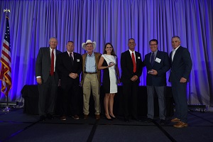 The VFW and Gordan Logan accepting a silver award of the Support Our Veterans Award by the International Franchise Association